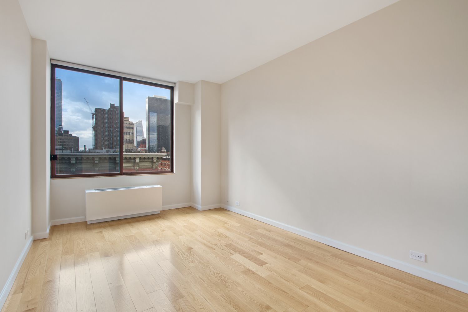 393 West 49th Street, Unit 6G Manhattan, NY 10019 - Photo 4 of 11 a view of an empty room with a window