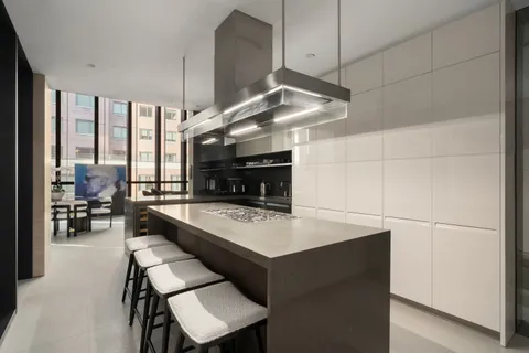 a large kitchen with a table and chairs in it