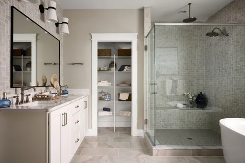 a bathroom with a double vanity sink toilet and shower
