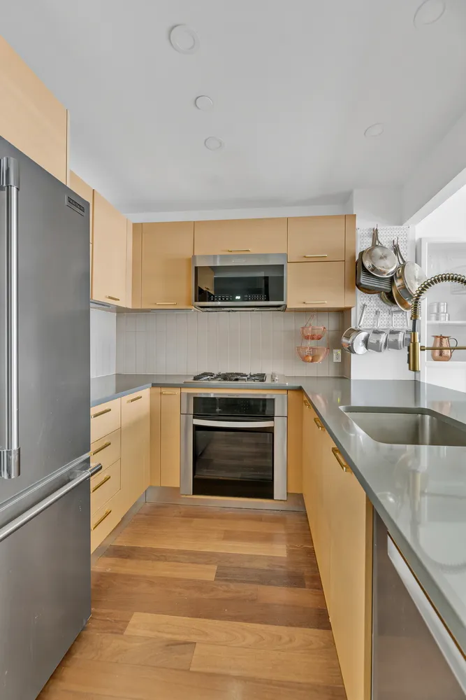 a kitchen with stainless steel appliances granite countertop a sink and a stove top oven