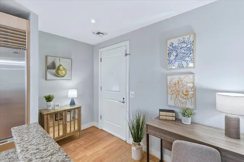a living room with furniture and painting on the wall