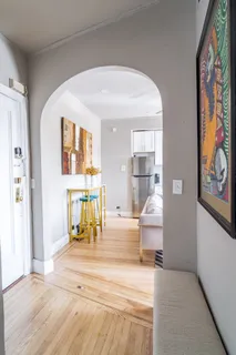 a view of an entryway with wooden floor
