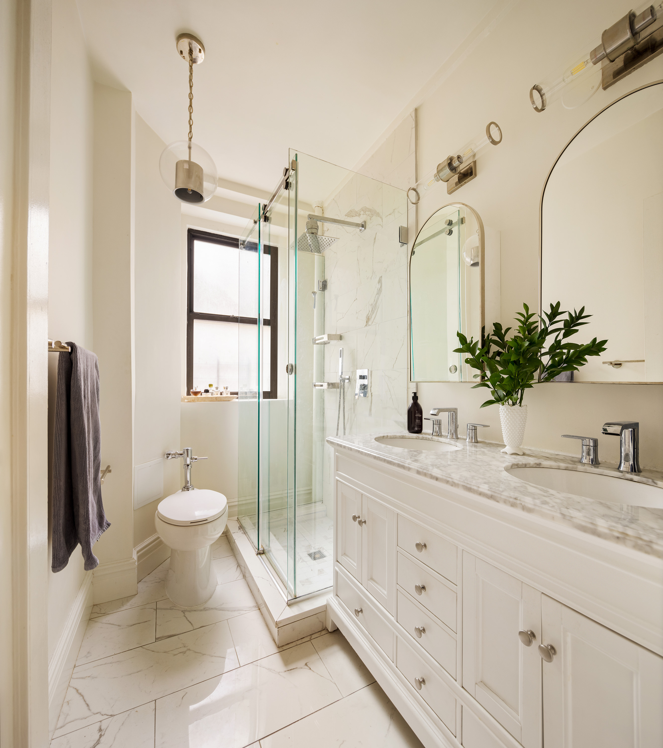 114 East 84th Street, Unit 3C Manhattan, NY 10028 - Photo 8 of 15 a spacious bathroom with a granite countertop sink mirror and toilet