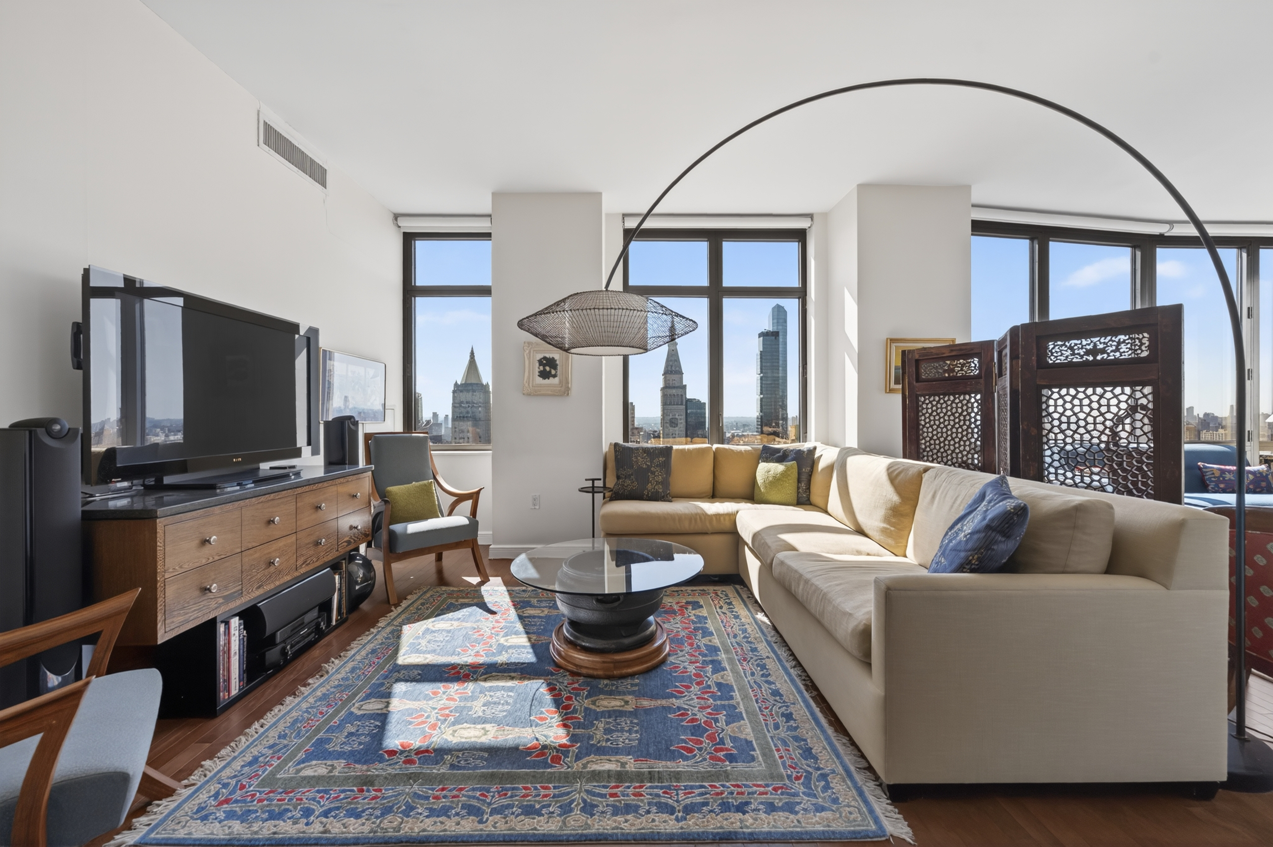 101 West 24th Street, Unit 36C Manhattan, NY 10011 - Photo 7 of 27 a living room with furniture and a flat screen tv