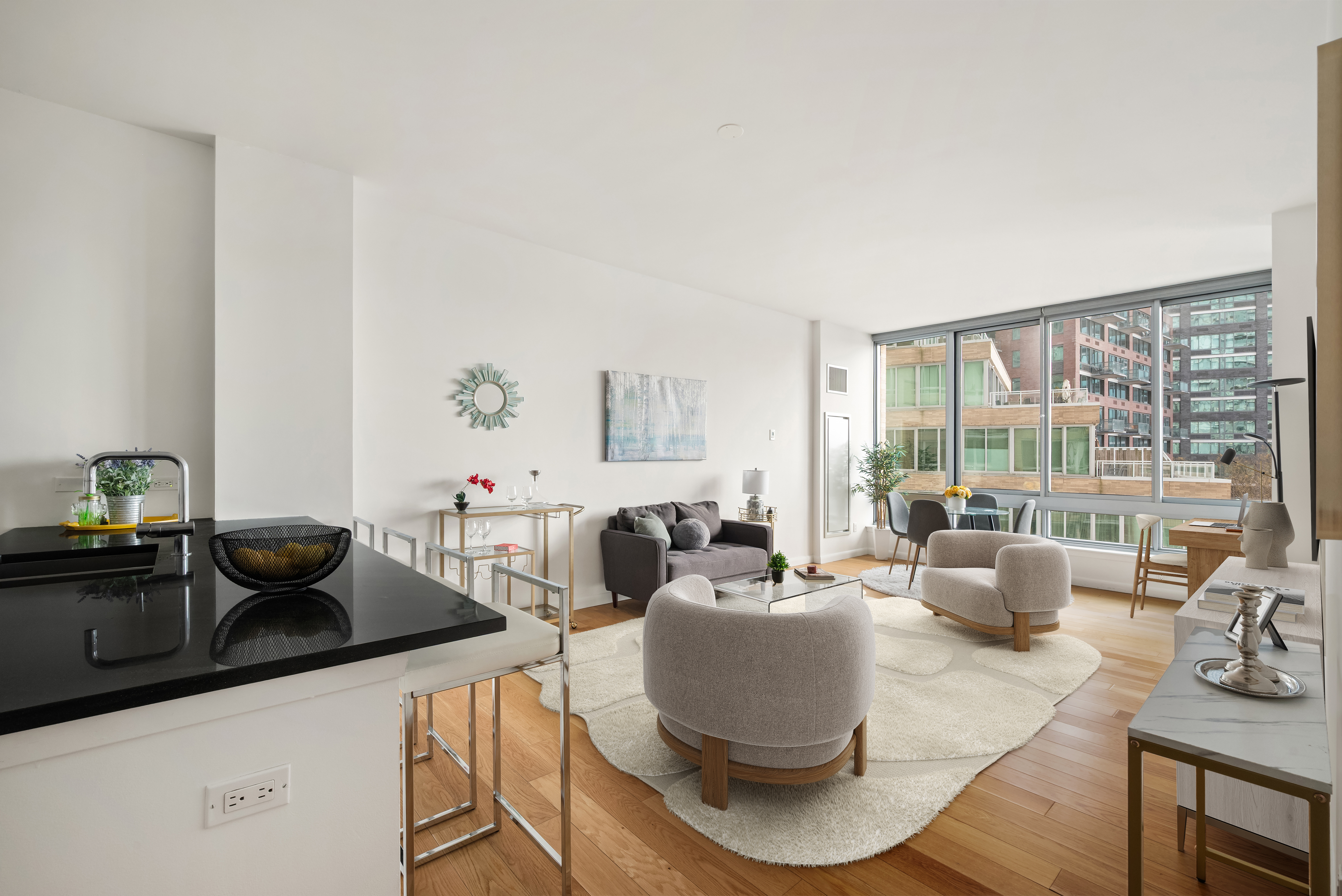 46-30 Center Boulevard, Unit 406 Queens, NY 11109 - Photo 2 of 23 a living room with furniture and a large window