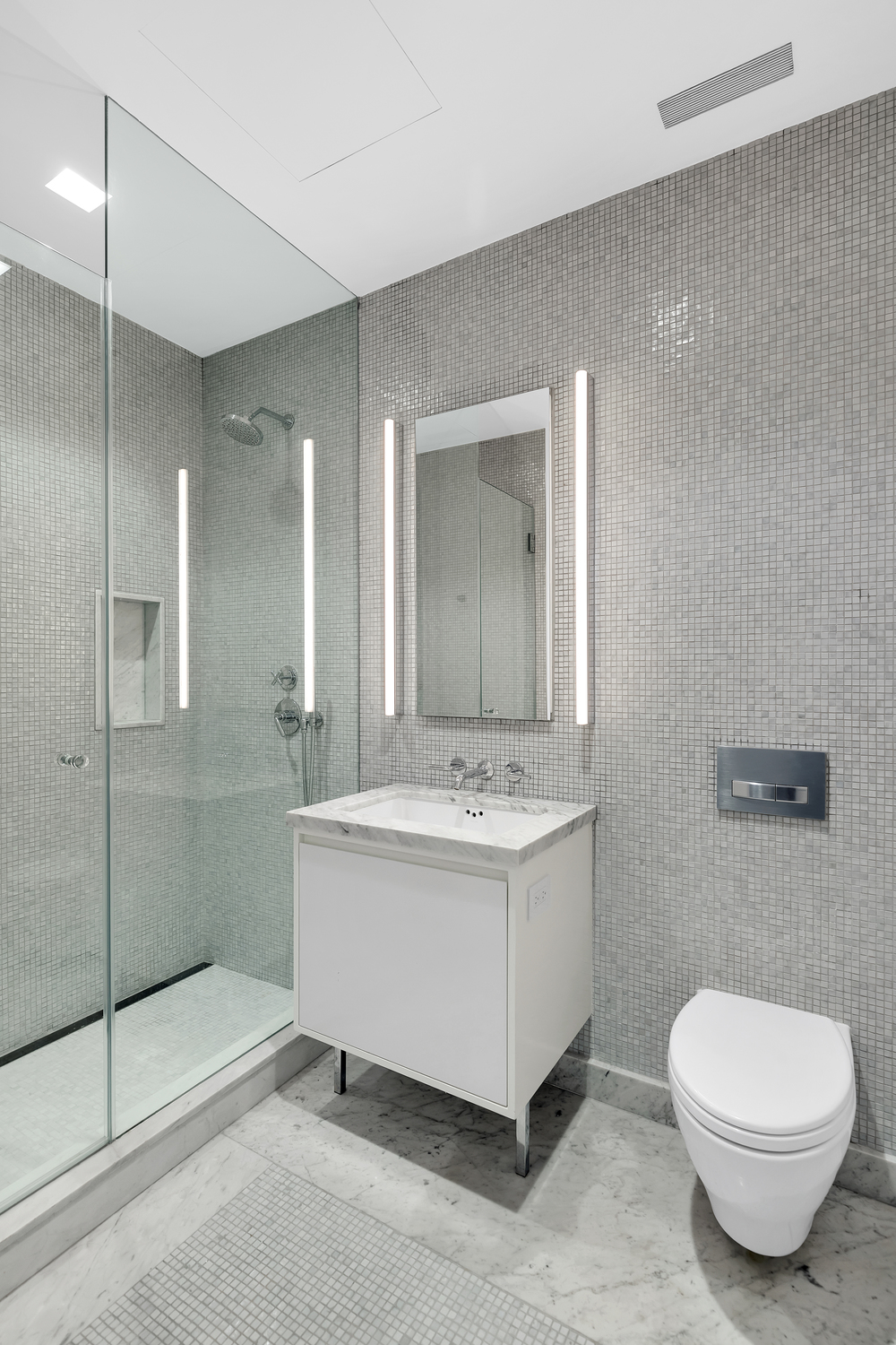 21 East 12th Street, Unit 19B Manhattan, NY 10003 - Photo 13 of 17 a bathroom with a sink a toilet and shower