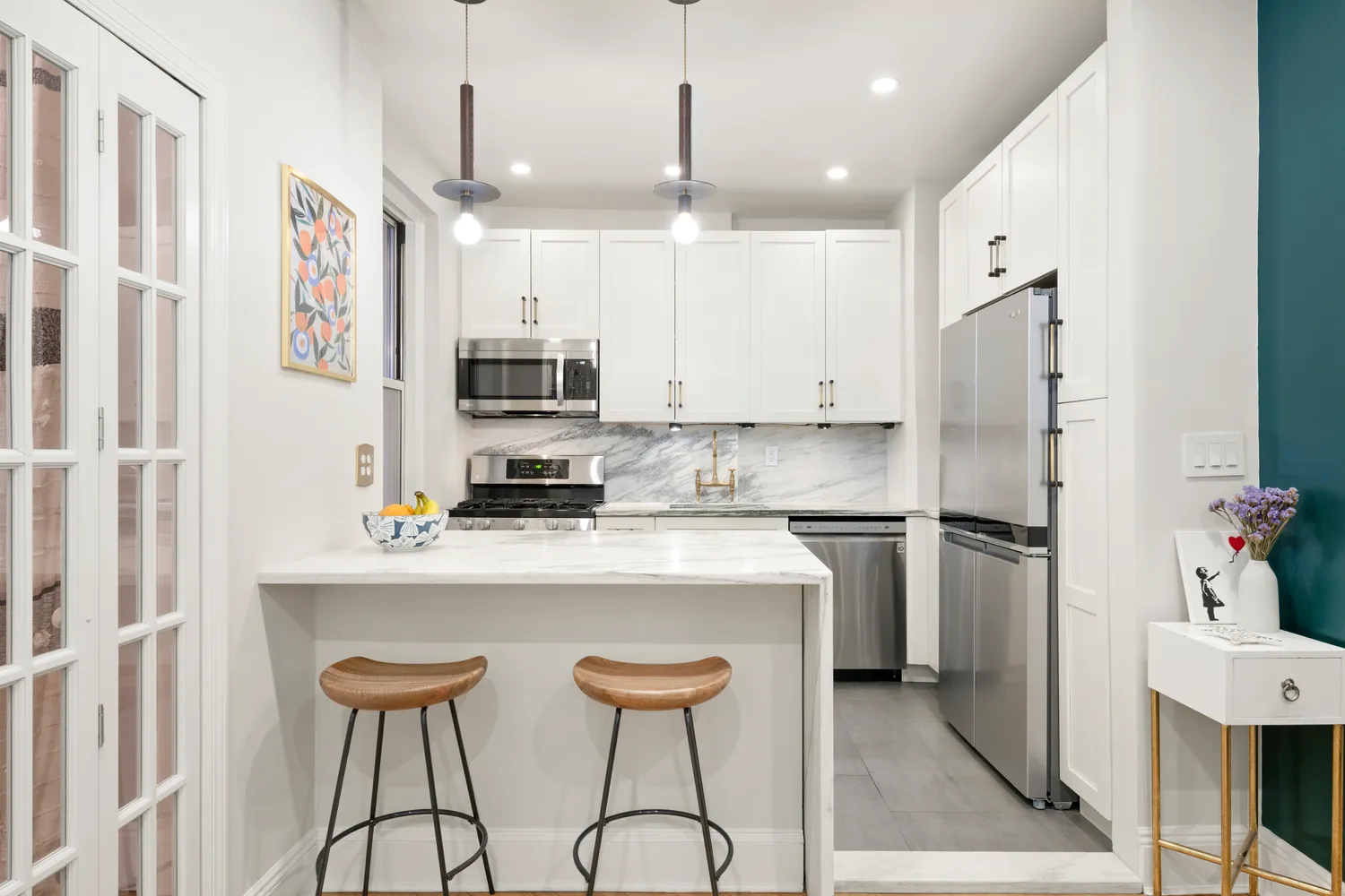 a kitchen with stainless steel appliances a refrigerator and a stove top oven