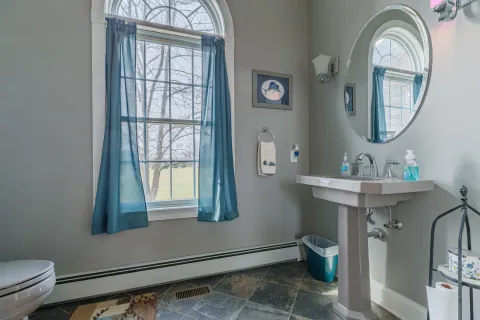 a spacious bathroom with a granite countertop sink and a mirror