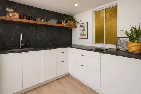 a kitchen with a sink and cabinets