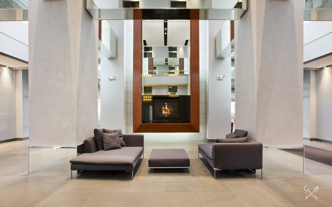 60 Broadway, Unit 10M Brooklyn, NY 11249 - Photo 10 of 12 a living room with furniture and a lamp