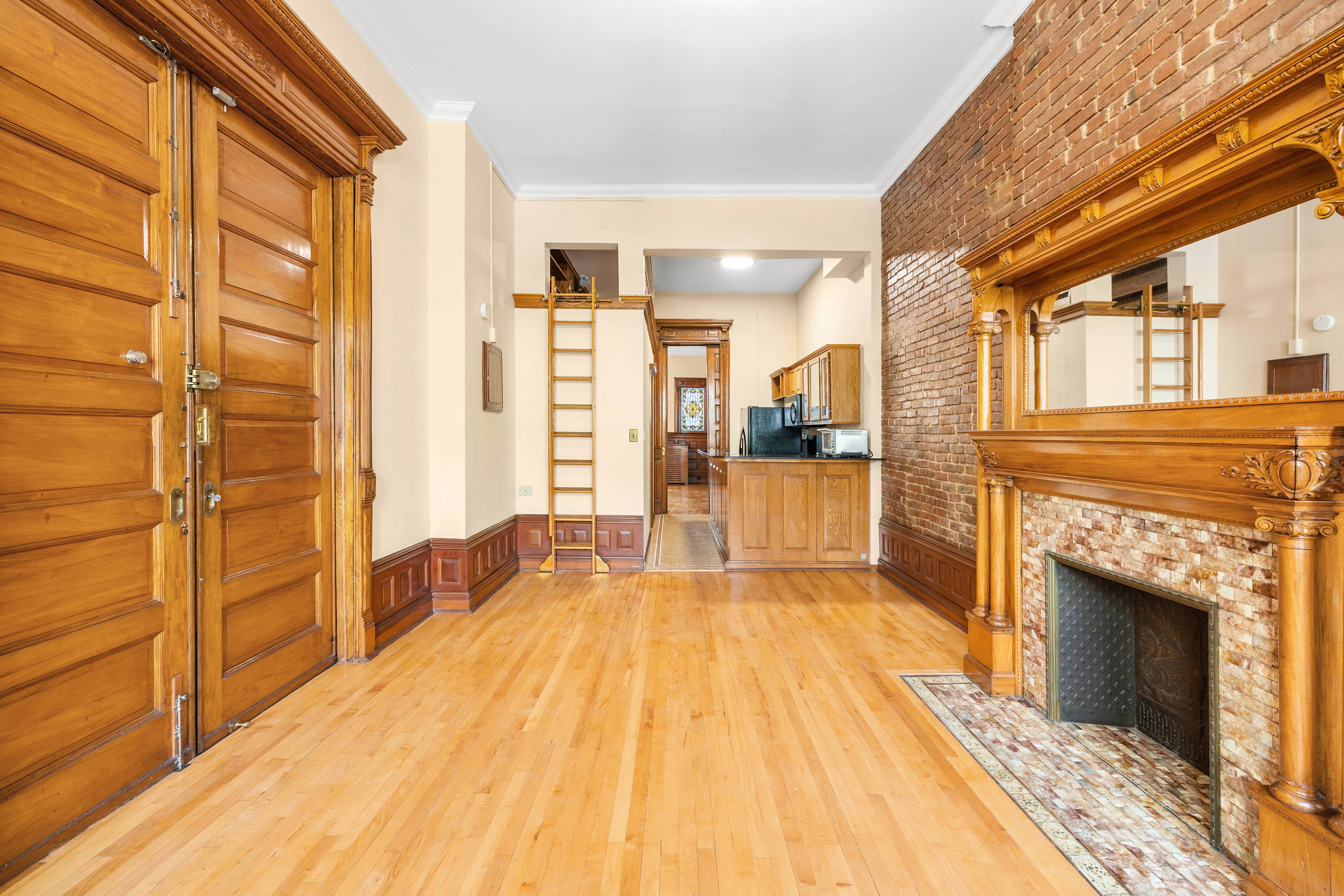 154 West 77th Street, Unit #1 Manhattan, NY 10024 - Photo 3 of 10 a spacious bedroom with a bed and a fireplace