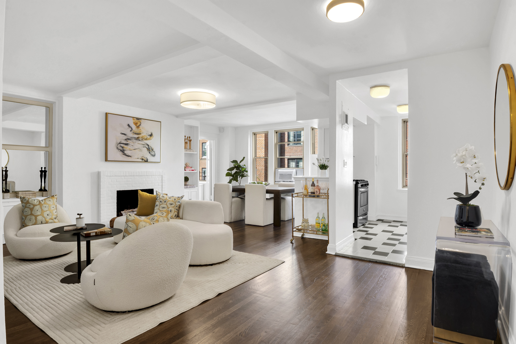 a living room with furniture a fireplace and kitchen view