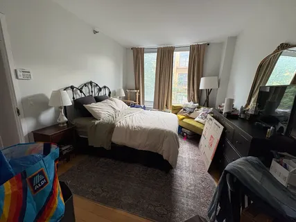 a bedroom with bed and window