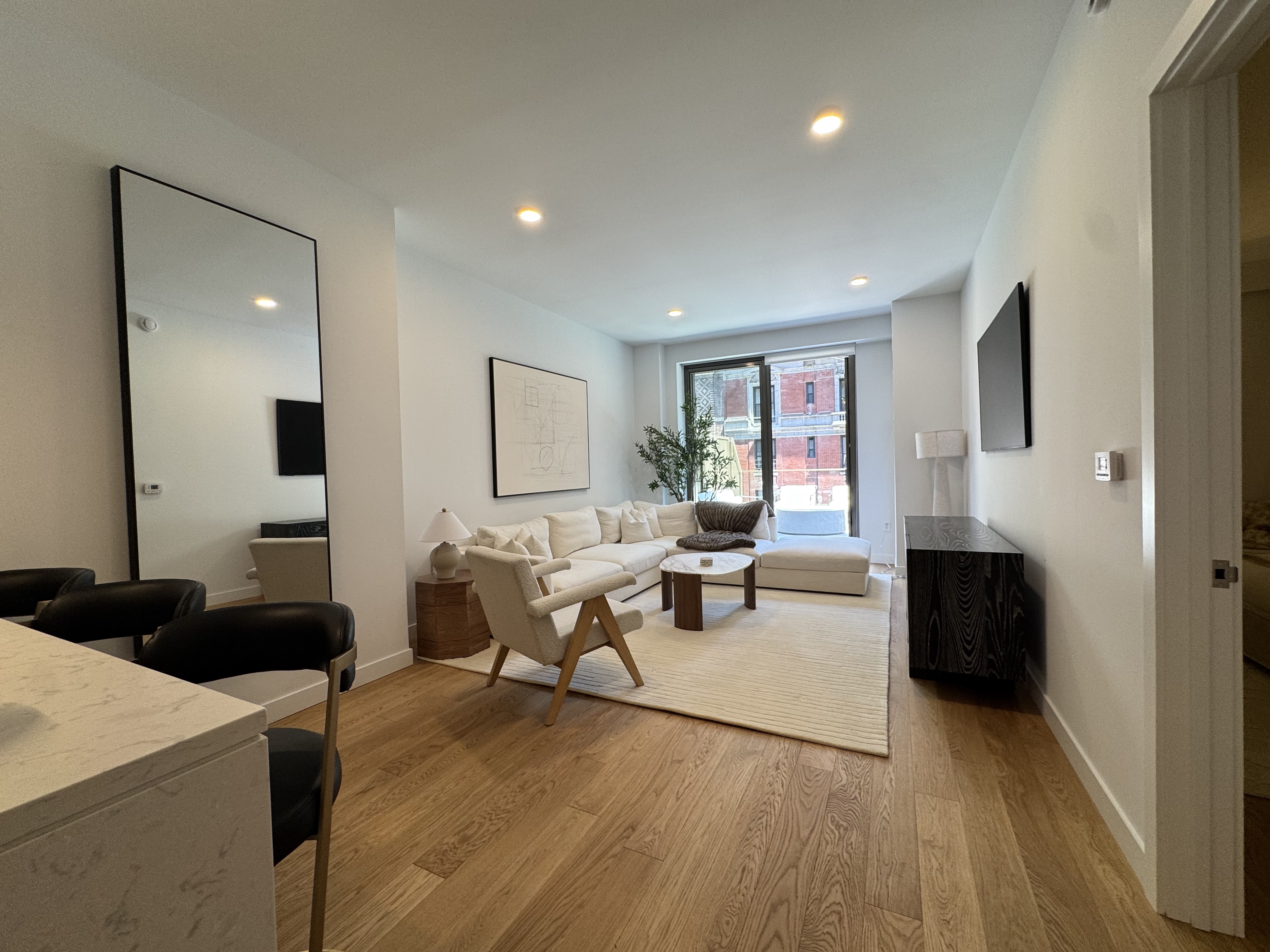 18 West 55th Street, Unit 7B Manhattan, NY 10019 - Photo 4 of 20 a living room with furniture and a fireplace
