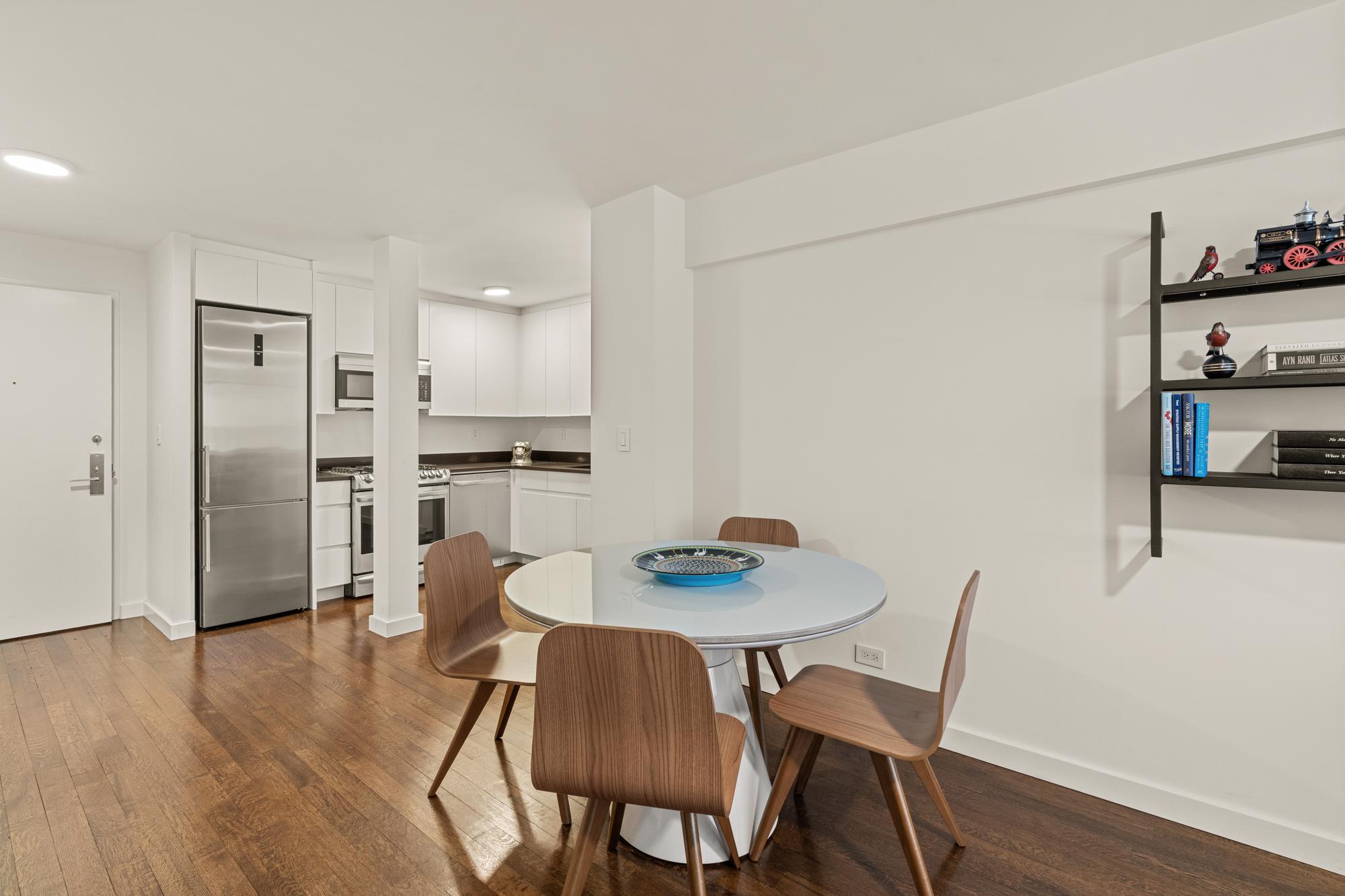 425 East 63rd Street, Unit W6A Manhattan, NY 10065 - Photo 3 of 11 a view of a dining room with furniture and wooden floor