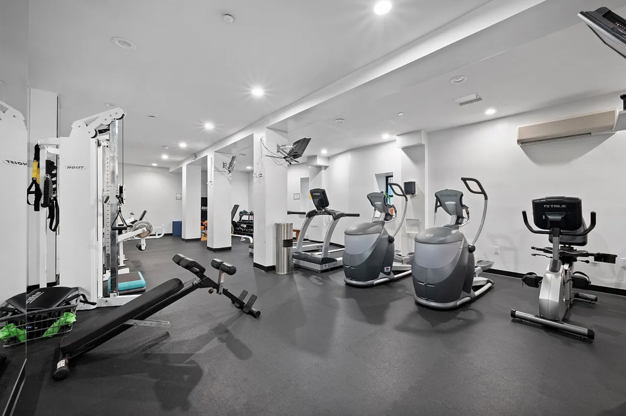 2098 Frederick Douglass Boulevard, Unit 7M Manhattan, NY 10026 - Photo 11 of 15 a room with gym equipment and a mirror