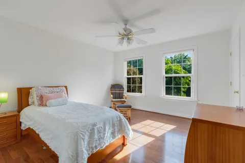 a bedroom with a bed and wooden floor