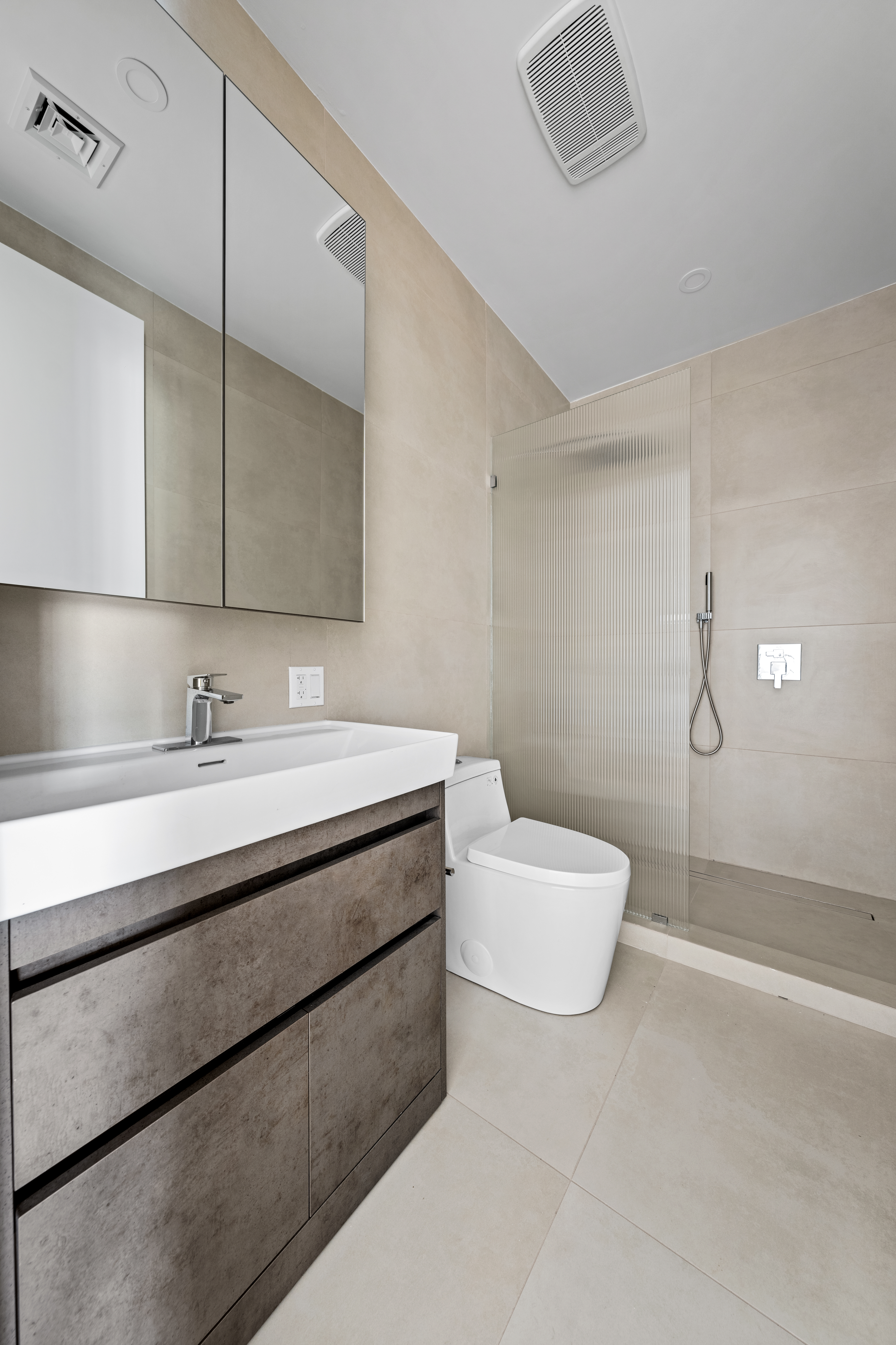 82 Cooper Street, Unit 2B Brooklyn, NY 11207 - Photo 7 of 17 a bathroom with a sink a toilet and mirror