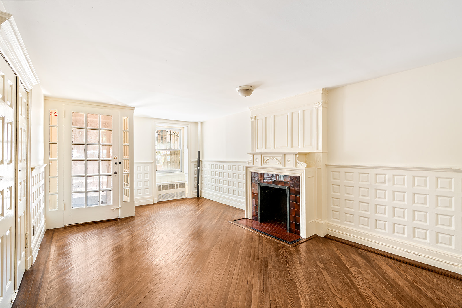 52 South Portland Avenue, Unit 1 Brooklyn, NY 11217 - Photo 1 of 7 wooden floor fireplace and windows in an empty room
