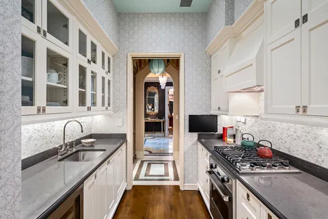 a spacious bedroom with a bed and a chandelier