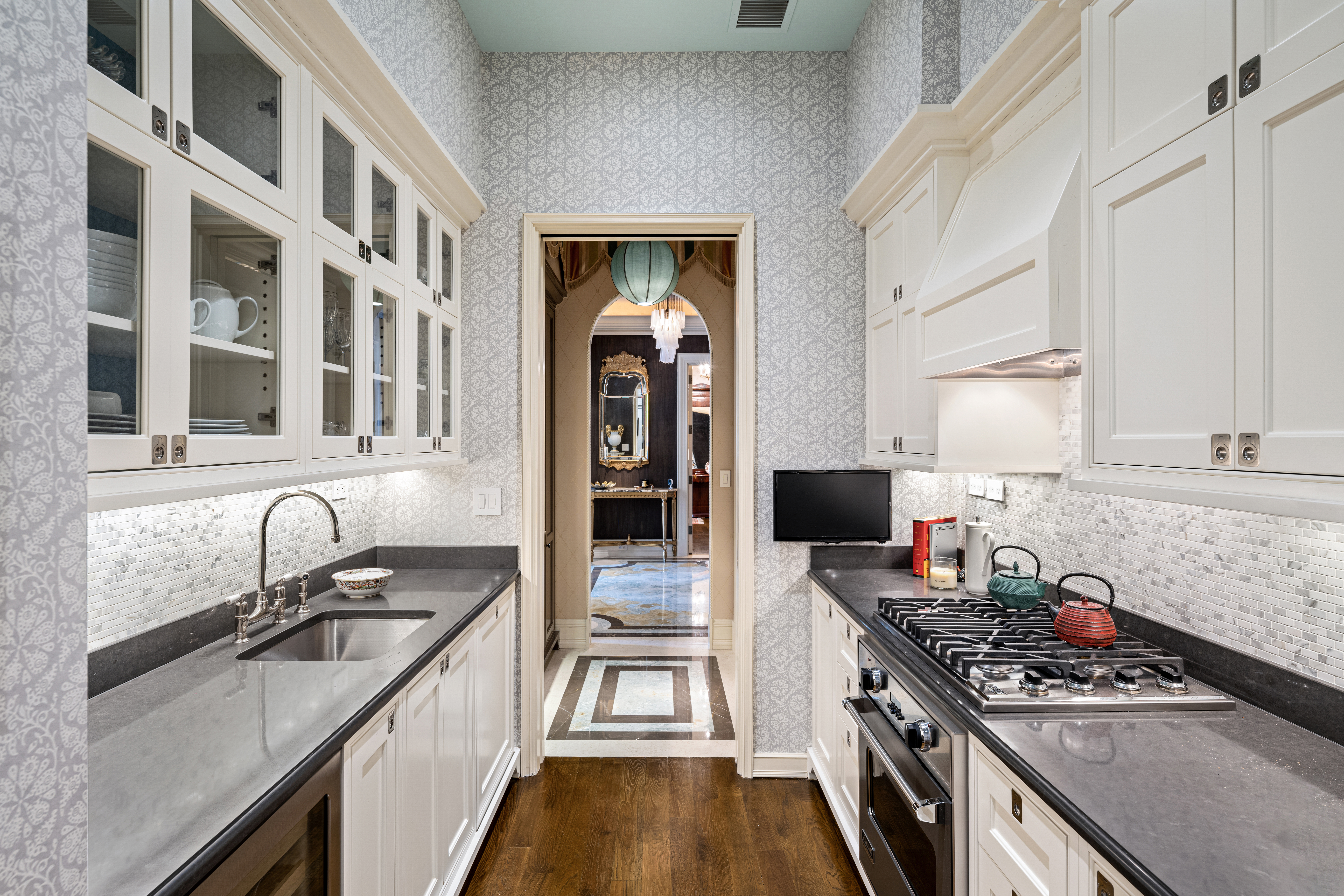 1 Central Park South, Unit 1013 Manhattan, NY 10019 - Photo 16 of 32 a kitchen with stainless steel appliances granite countertop a stove and a sink