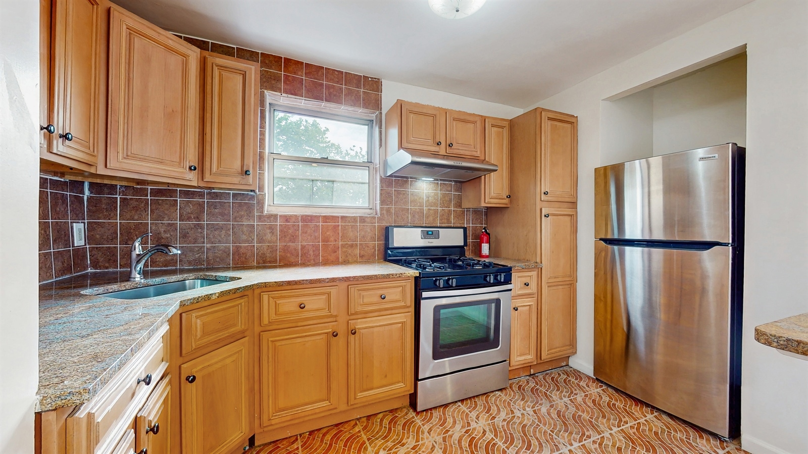 295 Conklin Avenue, Unit 3 Brooklyn, NY 11236 - Photo 3 of 15 a kitchen with stainless steel appliances granite countertop a refrigerator sink and stove