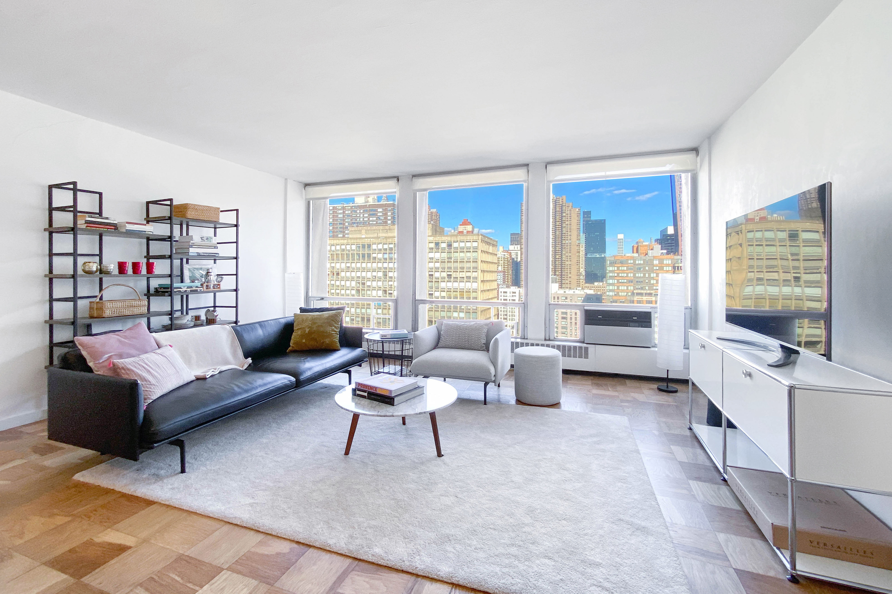 343 East 30th Street, Unit 18A Manhattan, NY 10016 - Photo 2 of 17 a living room with furniture and a flat screen tv