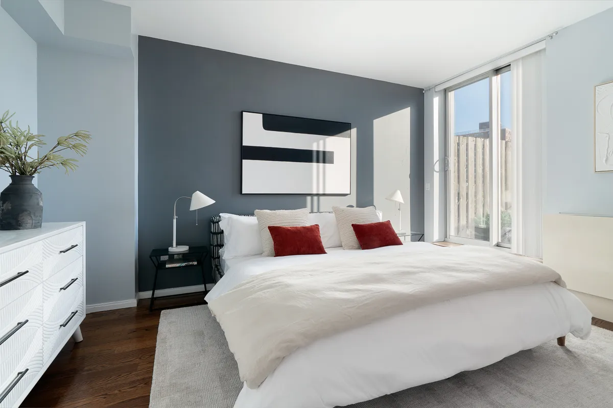 a bedroom with a bed and a potted plant