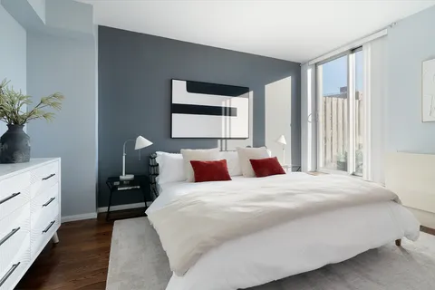 a bedroom with a bed and a potted plant