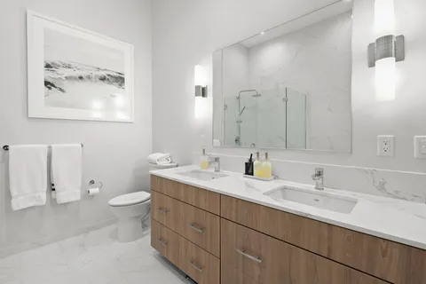 a bathroom with a toilet sink and mirror