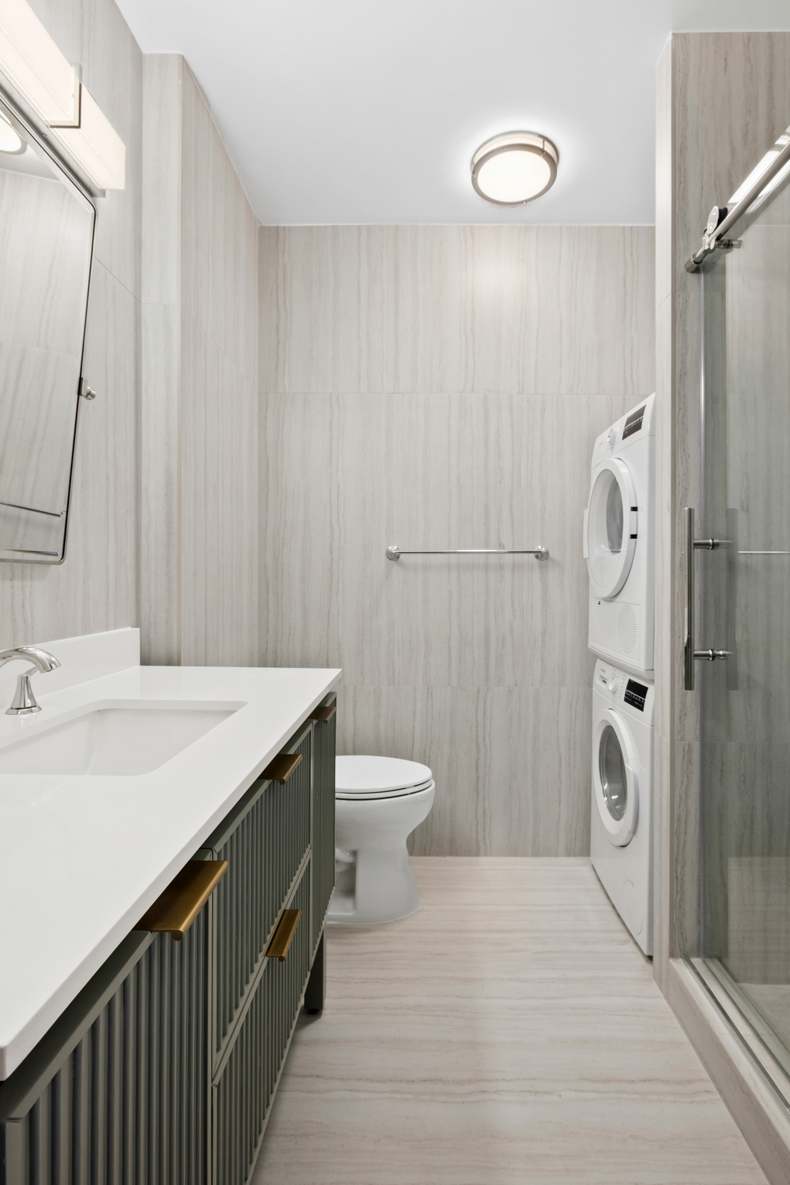 240 East 47th Street, Unit 27A Manhattan, NY 10017 - Photo 4 of 9 a bathroom with a sink a toilet and shower
