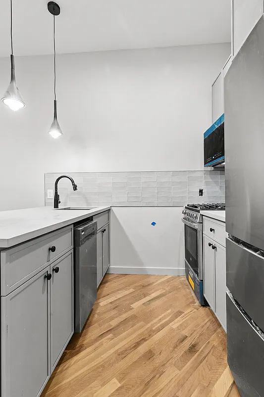 1265 Madison Street, Unit 2 Brooklyn, NY 11221 - Photo 3 of 9 a kitchen with a sink stove and refrigerator