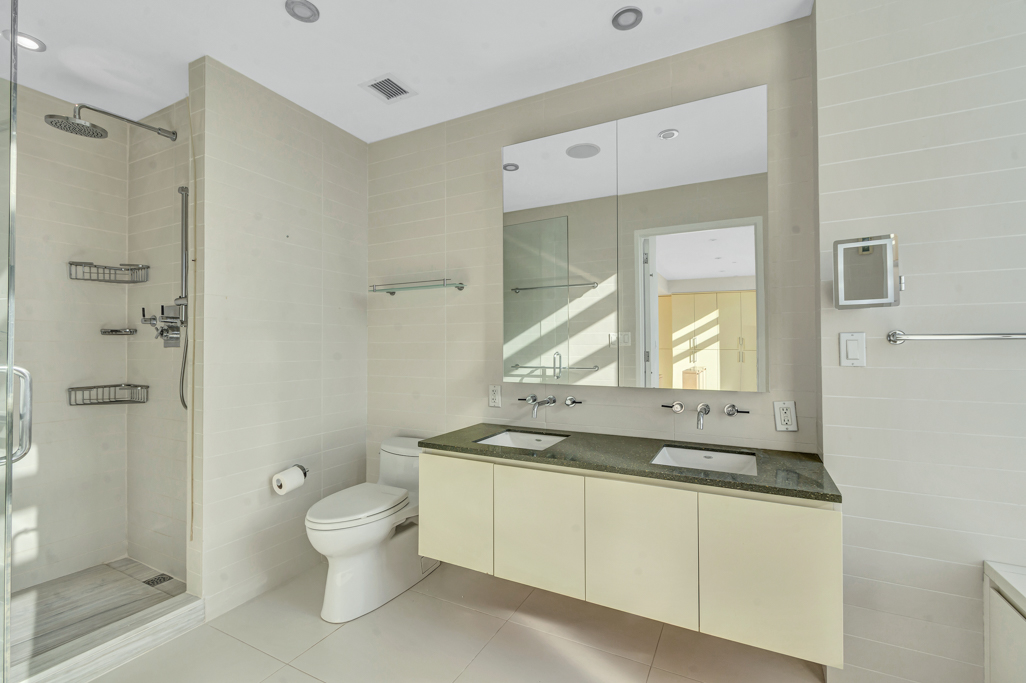 2 Northside Piers, Unit PH2 Brooklyn, NY 11249 - Photo 18 of 27 a bathroom with a granite countertop sink toilet and shower