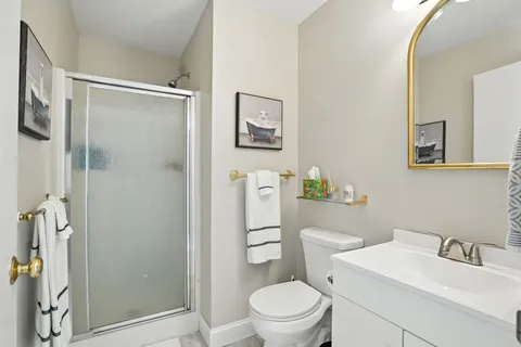 a white toilet sitting next to a bathroom sink