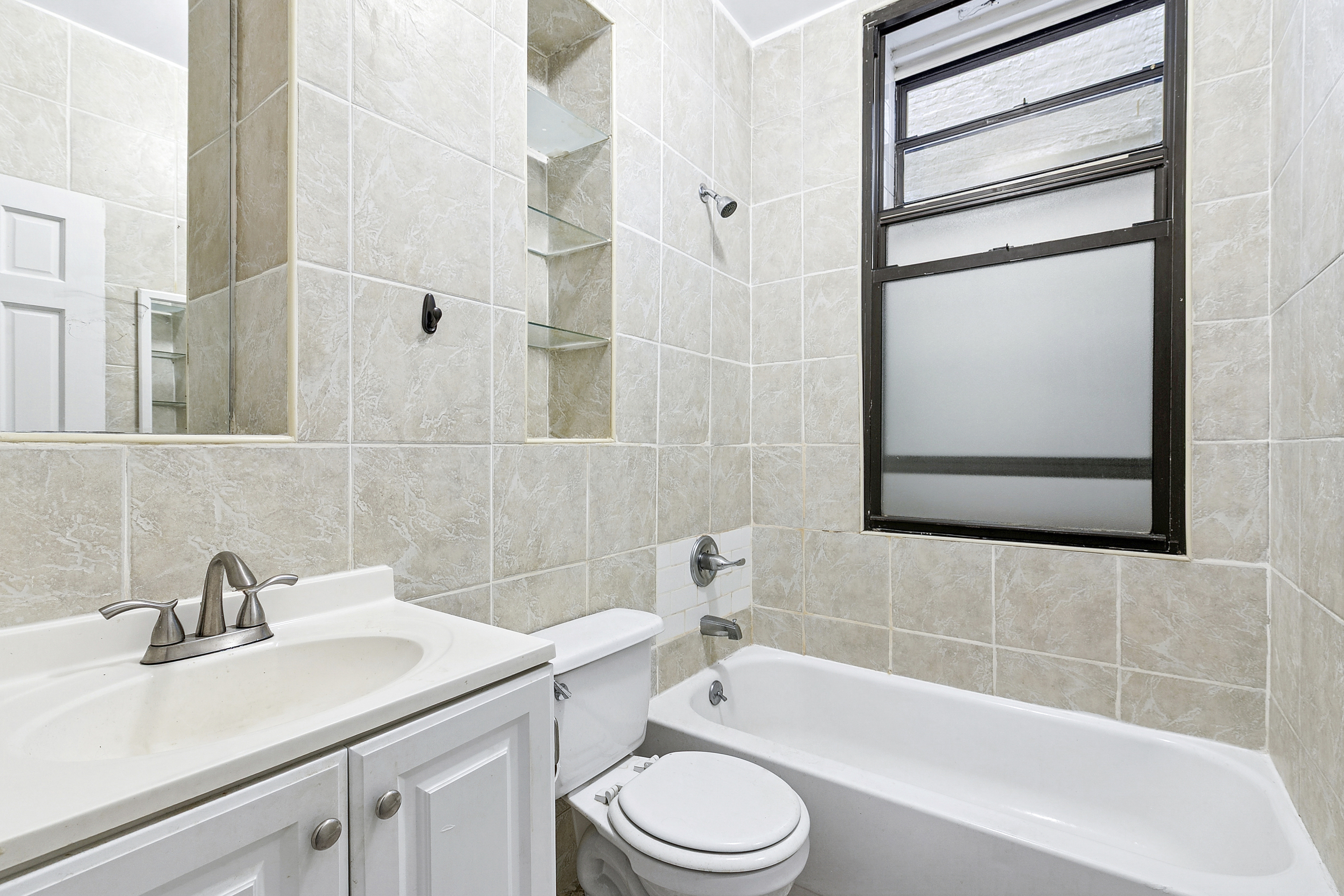 178 East 2nd Street, Unit 1B Manhattan, NY 10009 - Photo 9 of 11 a bathroom with a sink toilet and shower