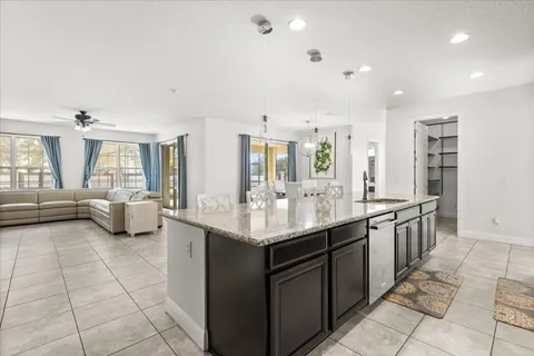 a kitchen with granite countertop a sink and a stove