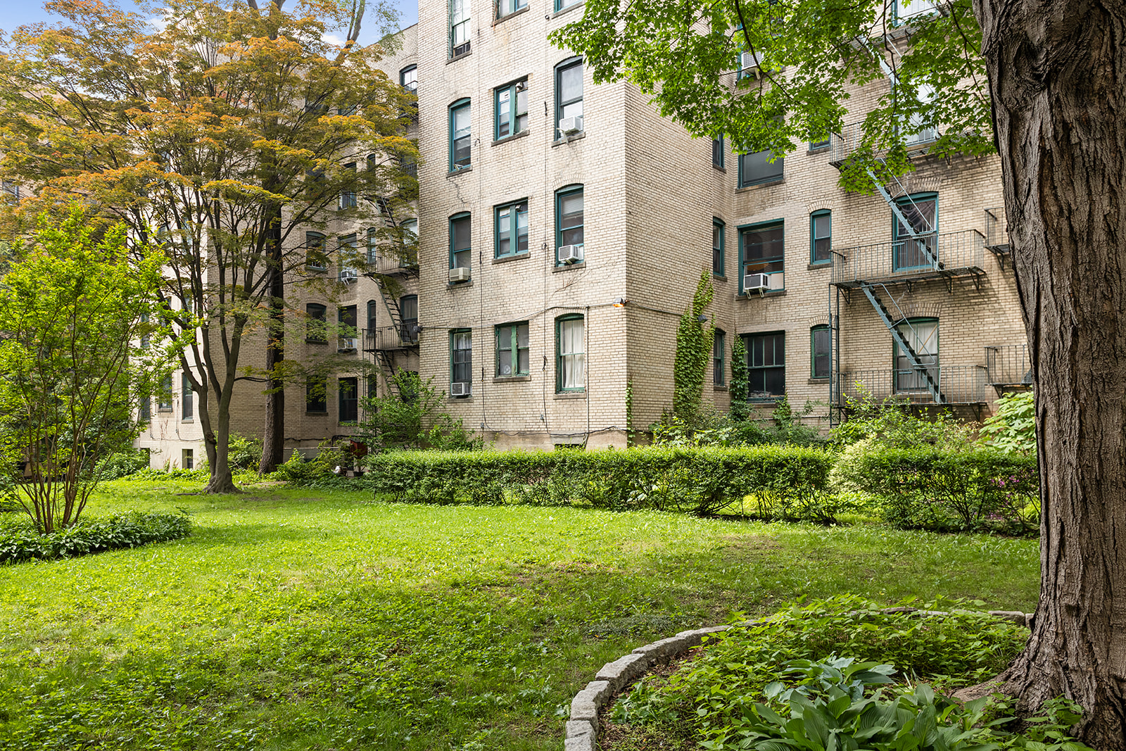 35-47 80th Street, Unit 21 Queens, NY 11372 - Photo 13 of 14 front view of a house with a yard