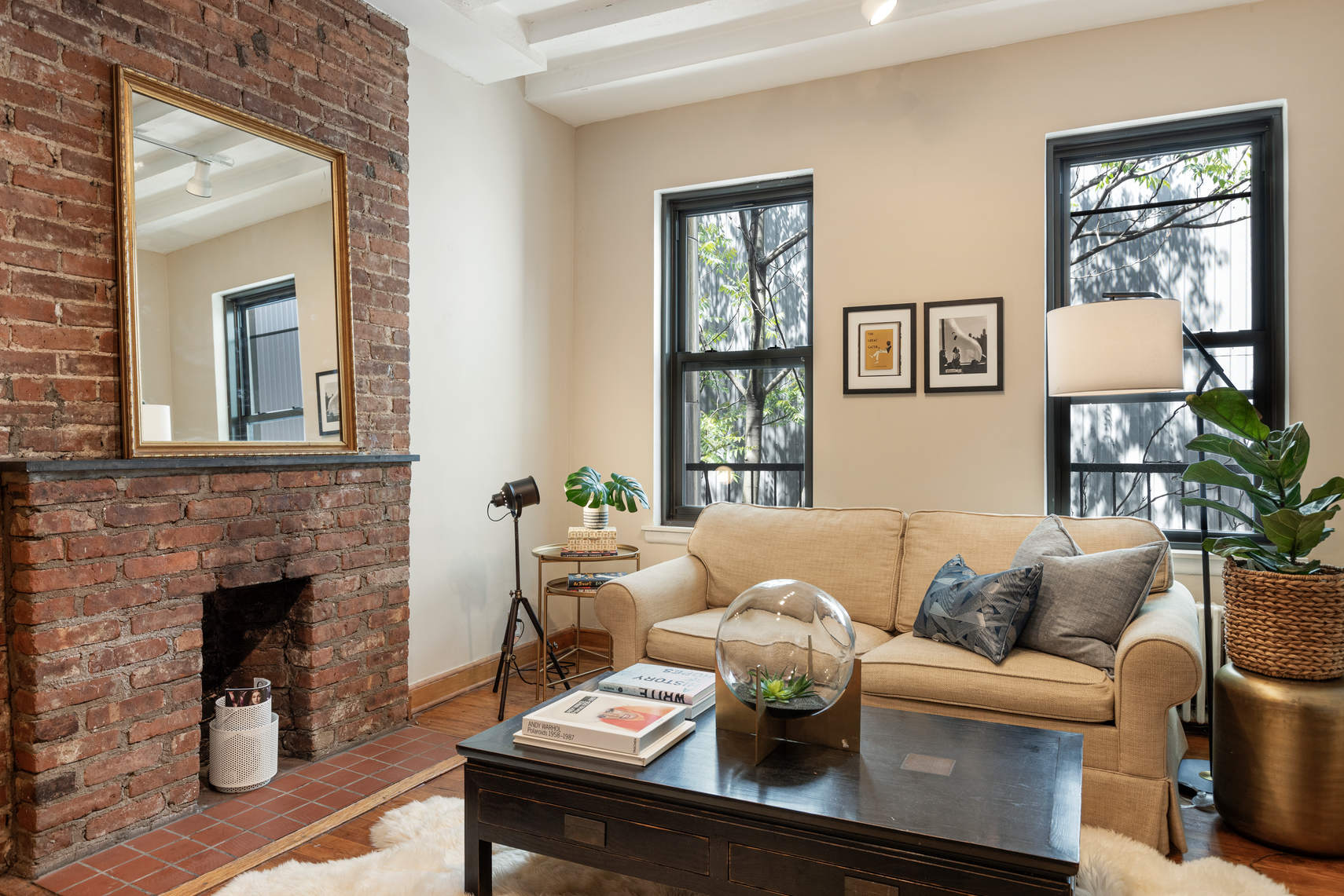 431 West 54th Street, Unit 4D Manhattan, NY 10019 - Photo 2 of 8 a living room with furniture and a fireplace