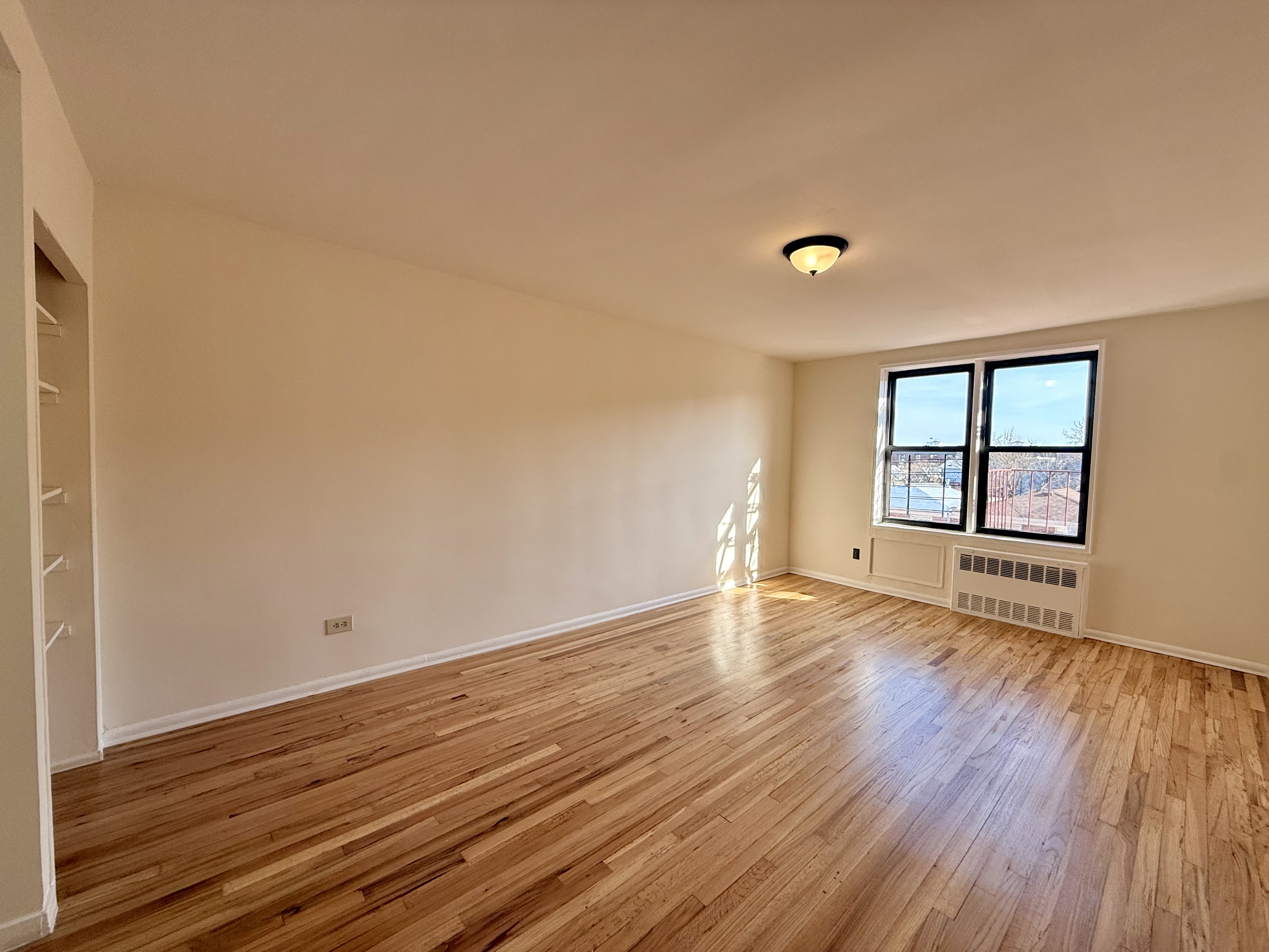 wooden floor in an empty room with a window