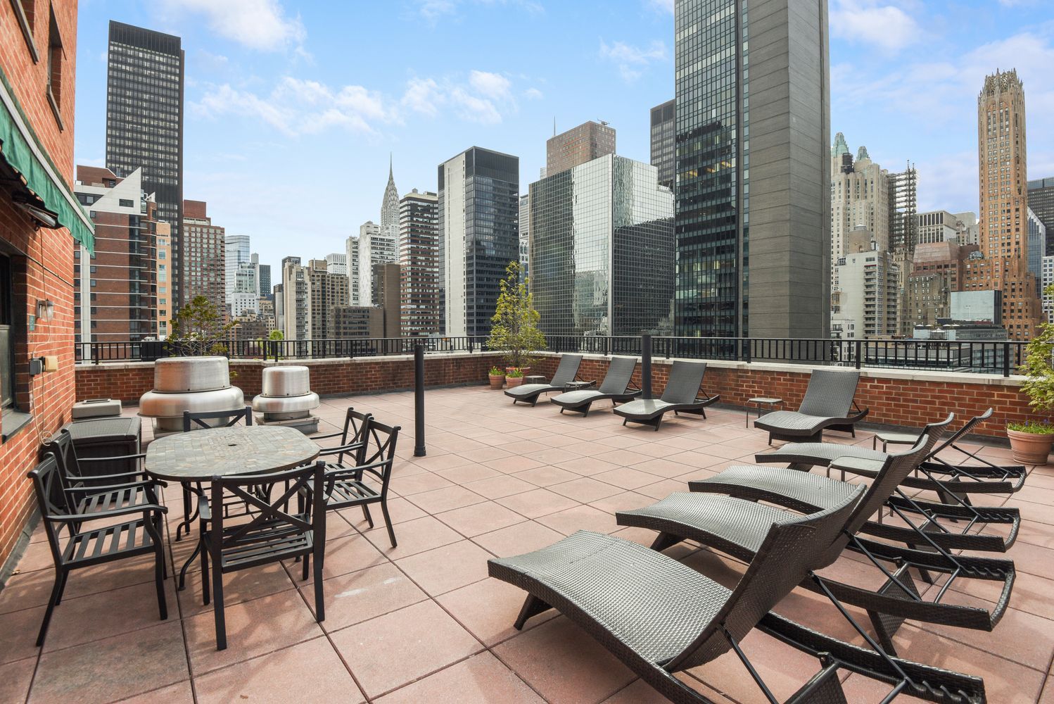 251 East 51st Street, Unit 5A Manhattan, NY 10022 - Photo 21 of 23 a view of a terrace with chairs and a table