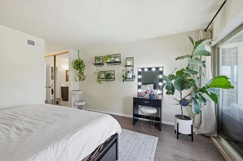 a bedroom with a bed potted plant and a window