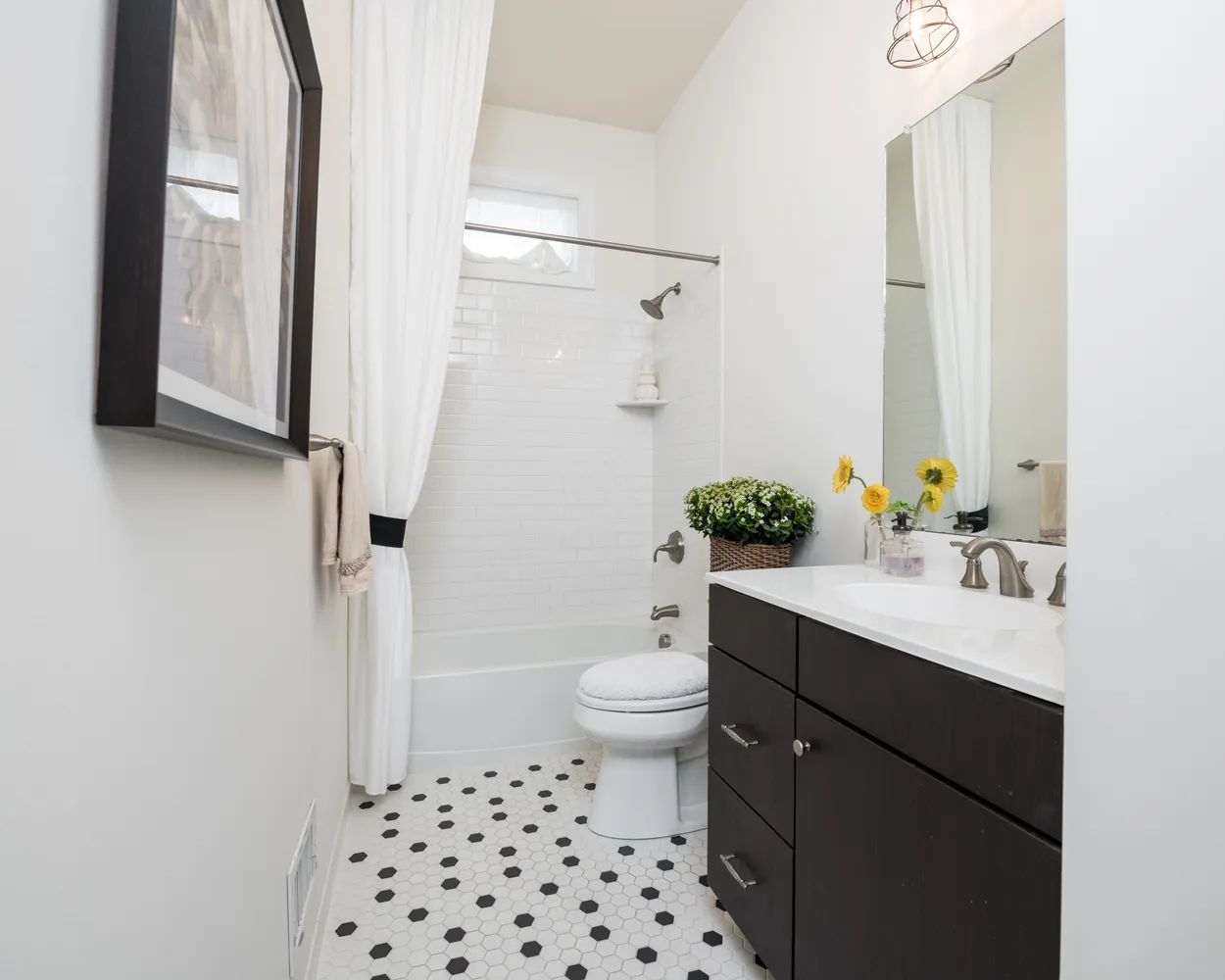 a bathroom with a sink a toilet a shower and a mirror