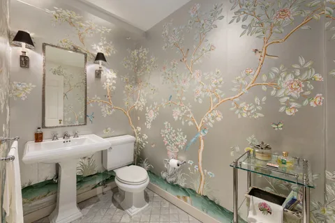 a bathroom with a toilet sink and mirror