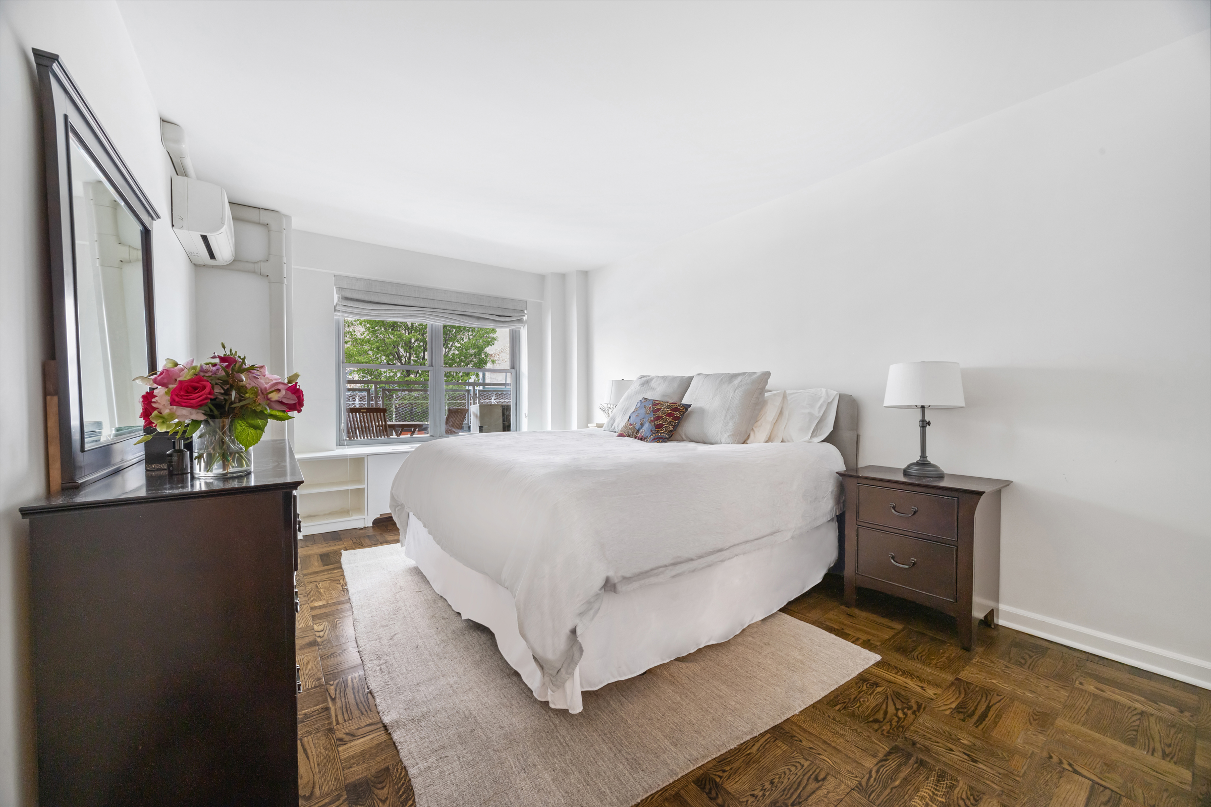 2 5th Avenue, Unit 2R Manhattan, NY 10011 - Photo 7 of 12 a bedroom with a bed and a potted plant