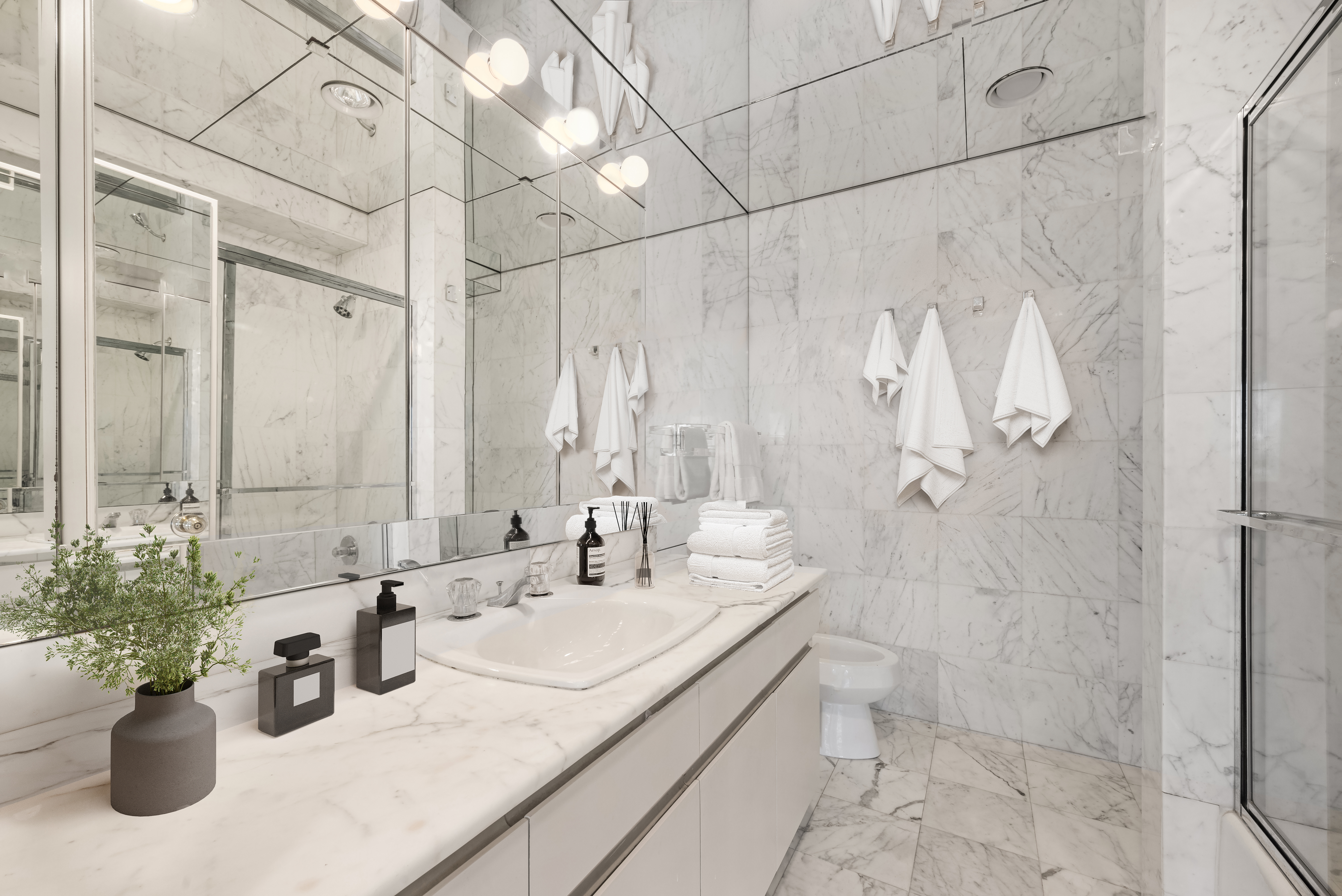 167 East 61st Street, Unit 29C Manhattan, NY 10065 - Photo 7 of 17 a bathroom with a granite countertop sink a toilet and shower