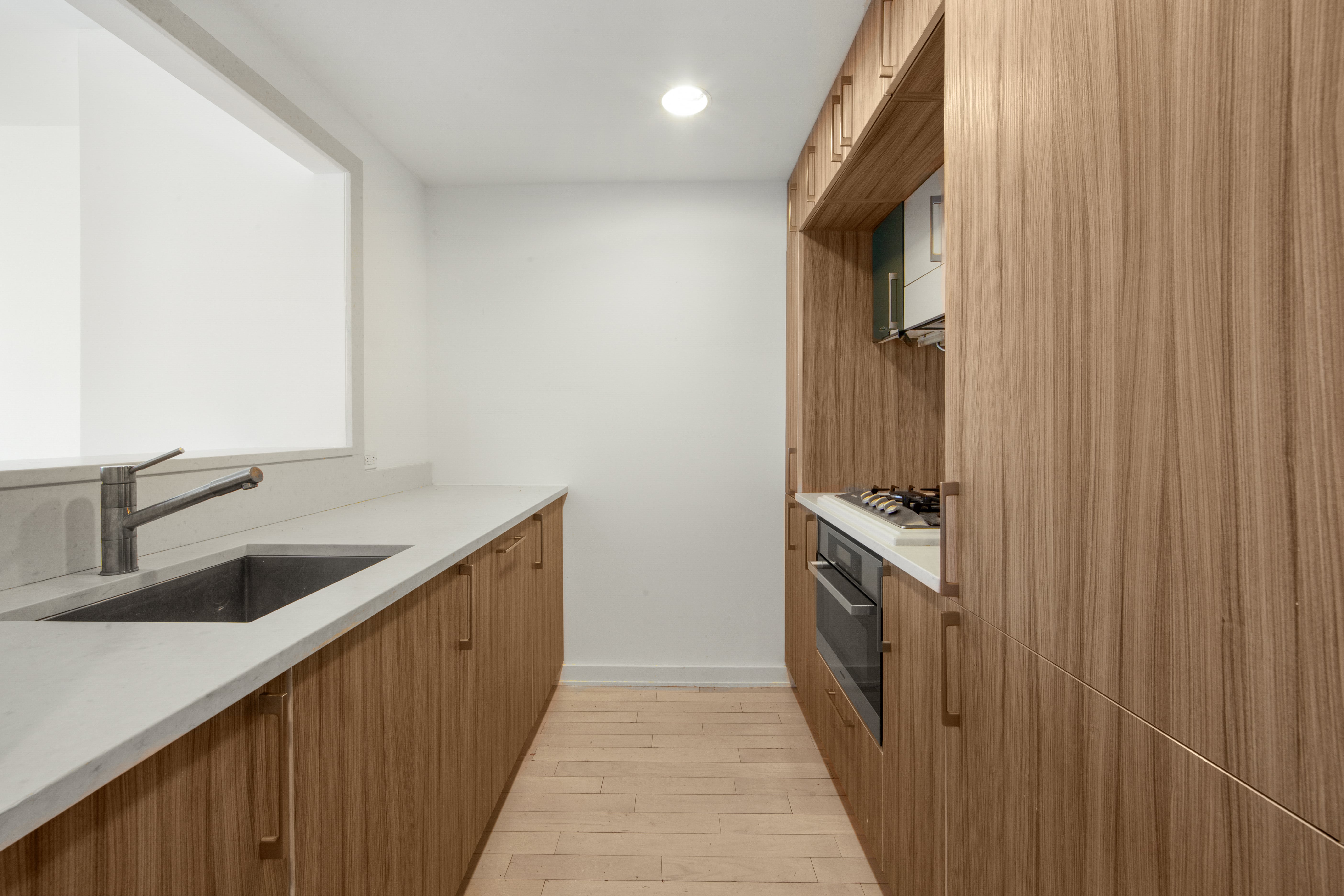 250 Bedford Avenue, Unit 129203 Brooklyn, NY 11249 - Photo 4 of 8 a kitchen with stainless steel appliances granite countertop a sink and a stove
