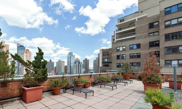 235 East 87th Street, Unit 10B Manhattan, NY 10128 - Photo 9 of 12 a view of a patio with couches and potted plants