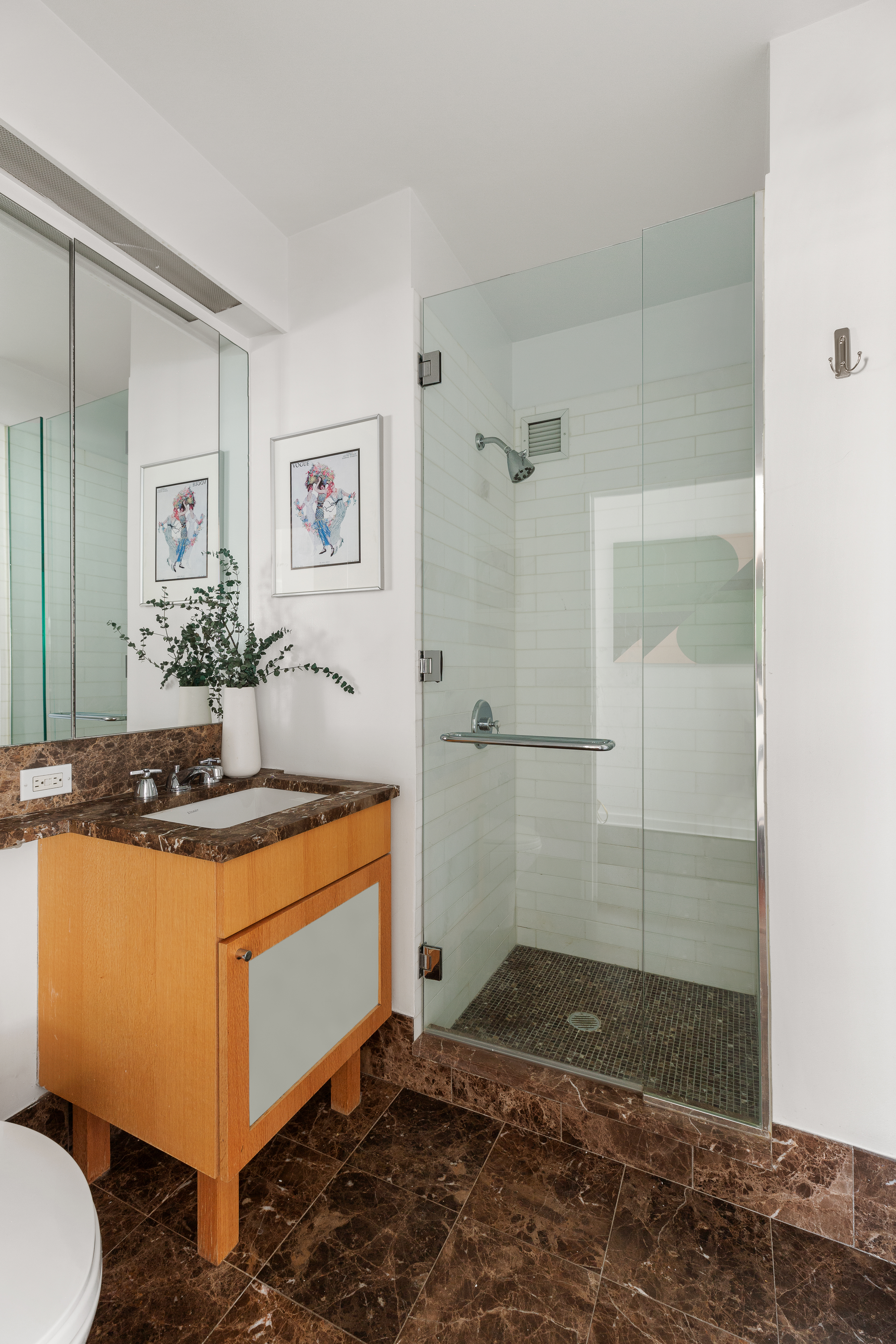 207 East 57th Street, Unit 18A Manhattan, NY 10022 - Photo 9 of 10 a view of a bathroom with a sink and mirror