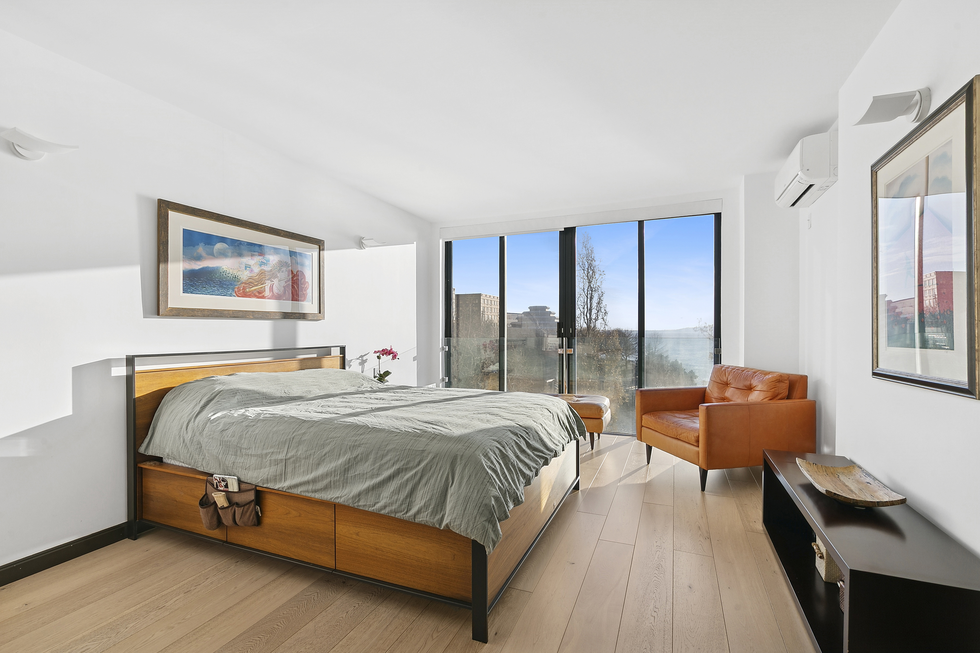 21 South End Avenue, Unit 402 Manhattan, NY 10280 - Photo 5 of 13 a bedroom with a bed and glass window