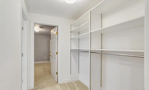 a bathroom with a sink vanity mirror and toilet